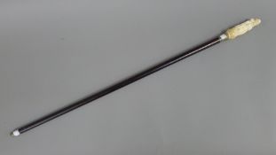 A carved bone erotic handled walking stick. 90.5 cm long.