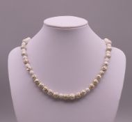 A Kerry Richardson designer silver and lava bead necklace. 42 cm long.