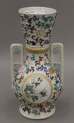 A 19th century Japanese vase hand painted on both sides with flowers and birds. 30.5 cm high.