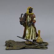 A cold painted bronze model of an Arab with a deer head. 14.5 cm high.