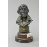 A bust of a Royal Air Force pilot on a wooden plinth base. 20 cm high overall.