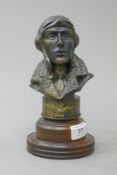 A bust of a Royal Air Force pilot on a wooden plinth base. 20 cm high overall.