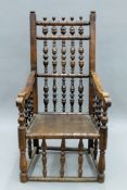 An 18th/19th century solid seated oak and elm bobbin twist arm chair. 58 cm wide.