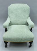 A Victorian upholstered open arm chair. 70 cm wide.