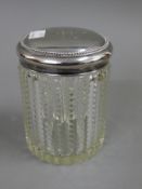 A sterling silver topped dressing table jar. 13.5 cm high.