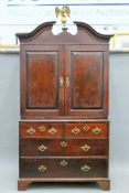 A Georgian mahogany linen press with gilt eagle surmount. Approximately 220 cm high x 118 cm wide.