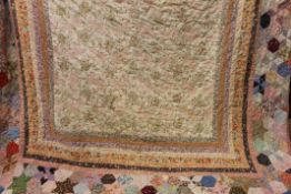 A vintage patchwork quilt. Approximately 200 cm long x 140 cm wide.