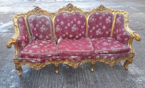 A gilt framed upholstered settee. Approximately 200 cm long.