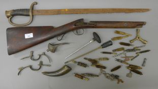 A quantity of gun tools, a gun stock and a sword.