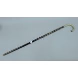 A silver handled walking cane,