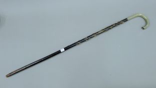 A silver handled walking cane,