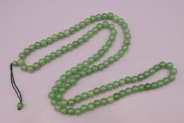 A jade necklace. Approximately 102 cm long.