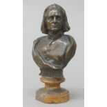 A patinated bronze bust of Liszt, mounted on a marble socle. 11.5 cm high.