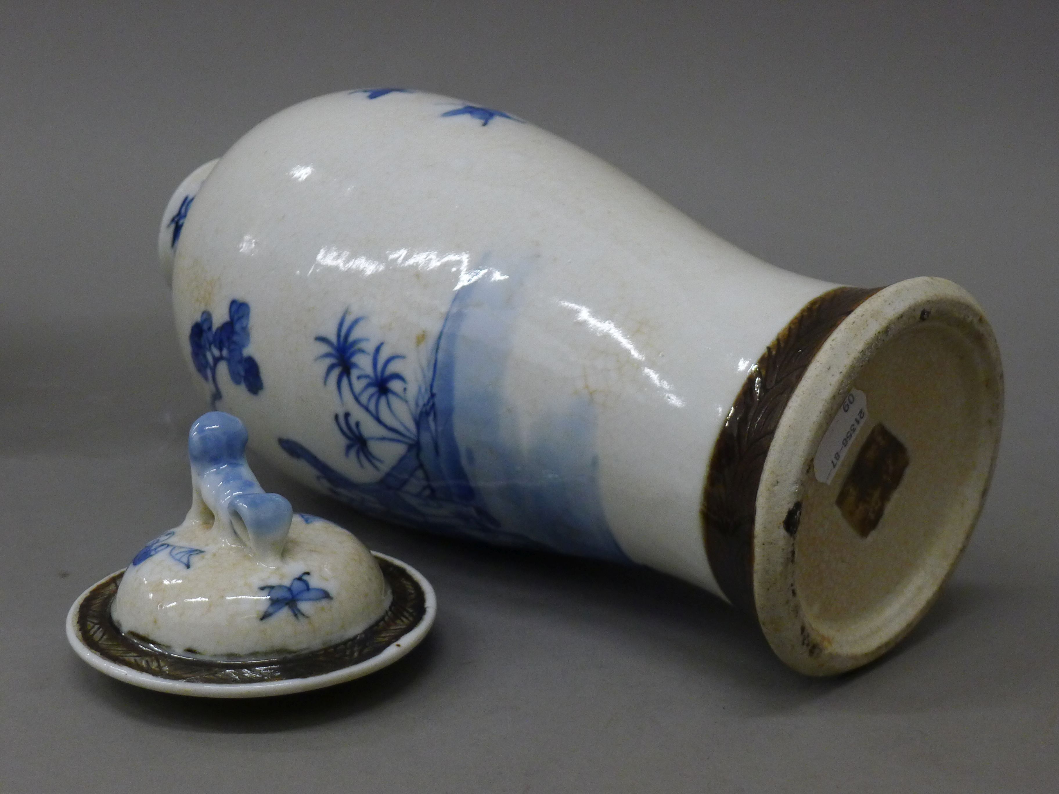 A pair of 19th century Chinese blue and white baluster vases and covers decorated with figures, etc. - Image 5 of 6