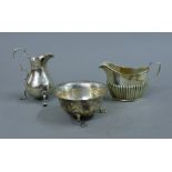 A silver cream jug, a silver sugar bowl and a silver milk jug. 218.6 grammes.