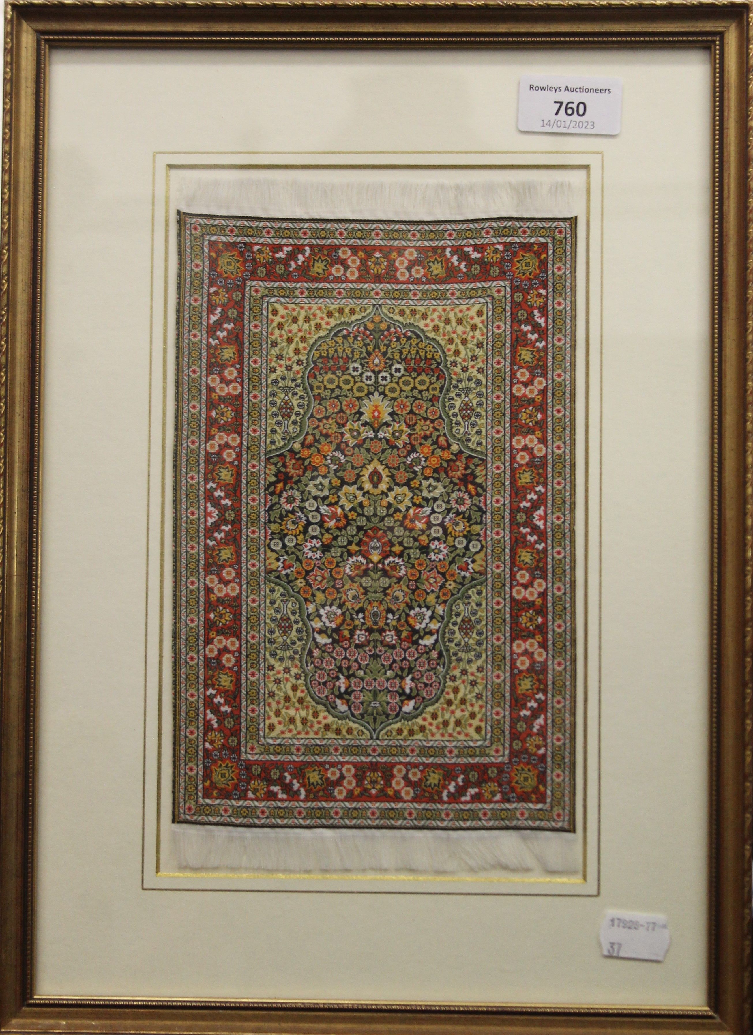 A framed and glazed miniature carpet. 28 x 38.5 cm overall. - Image 2 of 2