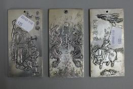 Three Chinese white metal ingots. 10 cm high.