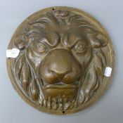 A cast metal lion's head roundel. 30 cm diameter.
