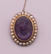 A 19th century seed pearl mounted carved hardstone cameo brooch. 3 cm high.