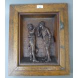 A late 19th century carved wooden panel in an oak frame, inscribed 'Give Us a Light'. 37 x 44.