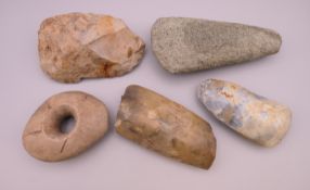 Four various Stone Age axe heads and a Stone Age hammer head. The largest 15 cm long.