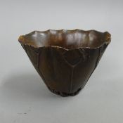 A libation cup decorated with a crab. 9 cm high.