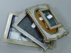 Four various silver photograph frames.