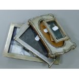 Four various silver photograph frames.