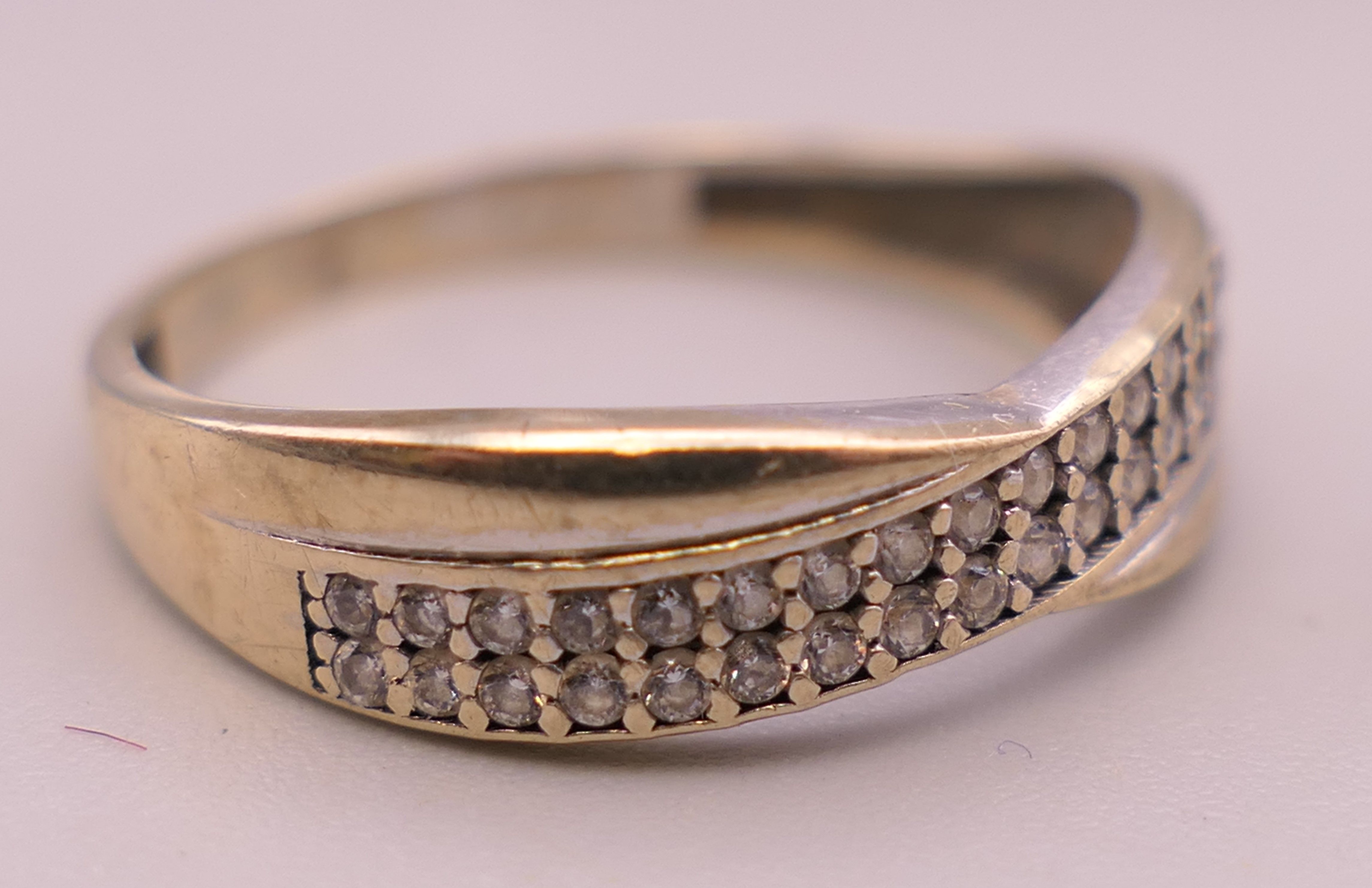 A 9 ct gold diamond set crossover ring. Ring size M. 1.3 grammes total weight. - Image 2 of 5
