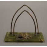 A letter rack surmounted with a lizard. 9.25 cm wide.