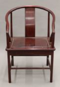 A Chinese hardwood open arm chair. 55 cm wide.