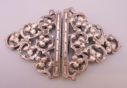 A silver nurse's buckle.