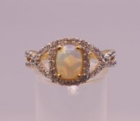 A silver opal and cubic zirconia ring. Ring size Q.