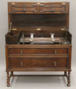 An early 20th century oak dressing chest with integral trouser press. 114.5 cm wide.