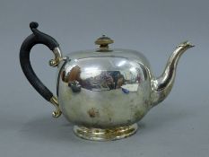 A silver teapot. 15 cm high. 16.7 troy ounces.