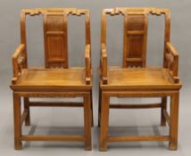 A pair of Chinese hardwood open arm chairs. 56 cm wide.