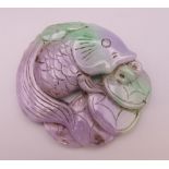 A lilac jade carving formed as a fish and money. 8 cm wide.