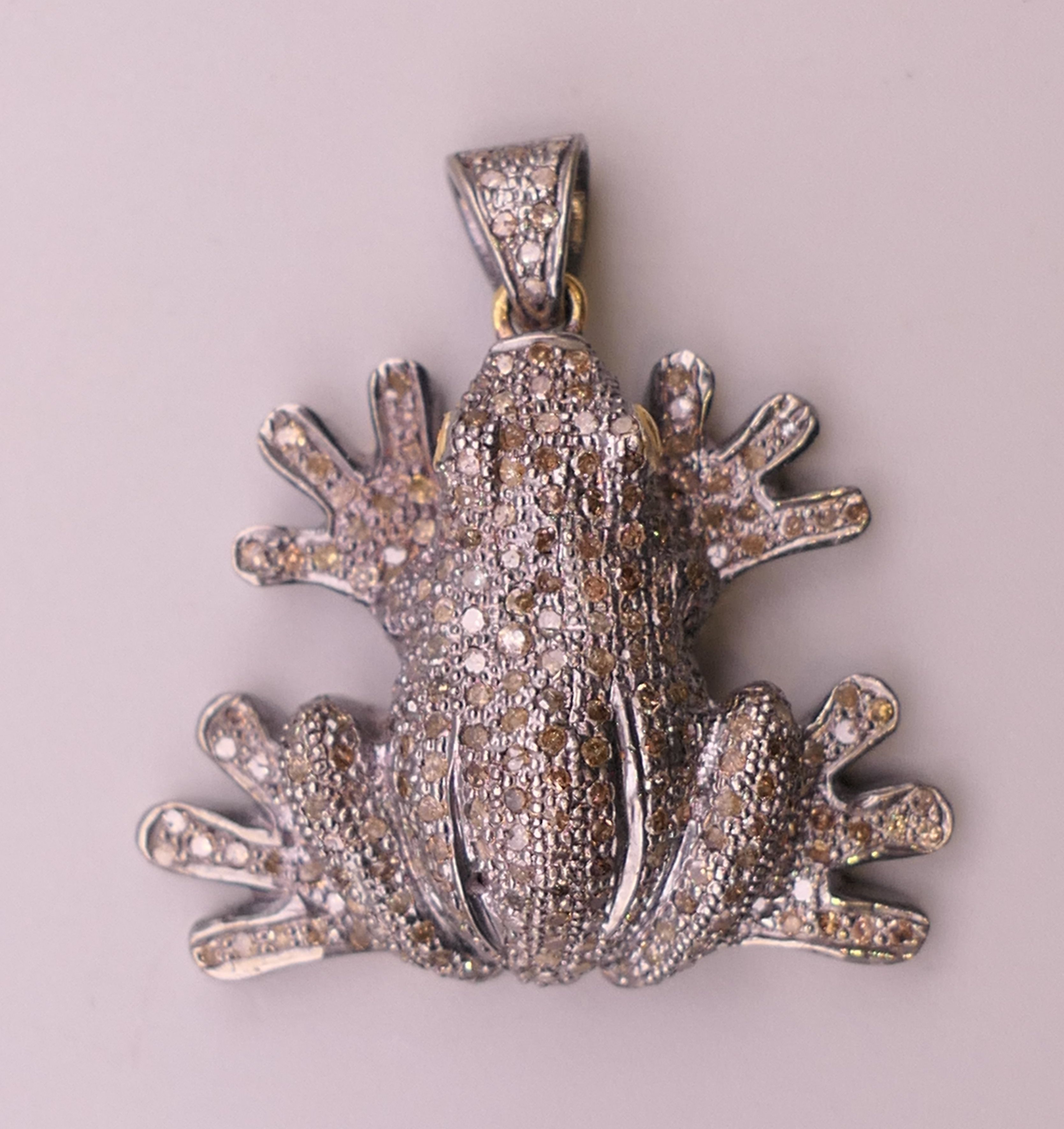 An unmarked diamond set pendant formed as a frog. 4 cm high. 16.3 grammes total weight.