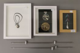 Three box frames containing Art pendants. The largest 24 x 31 cm.