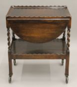 An early 20th century oak barley twist tea trolley. 61 cm long.