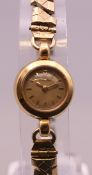 A 9 ct gold cased ladies Omega wristwatch on a plated strap. 1.5 cm wide.