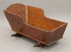 A 19th century wooden cradle. 95 cm long.