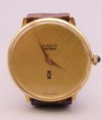 A Must de Cartier 18 K gold electro plated wristwatch. 3 cm wide.