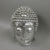 A silvered buddha head. 38 cm high.