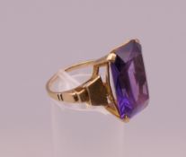 An unmarked gold amethyst ring. Ring size O/P. 7.3 grammes total weight.