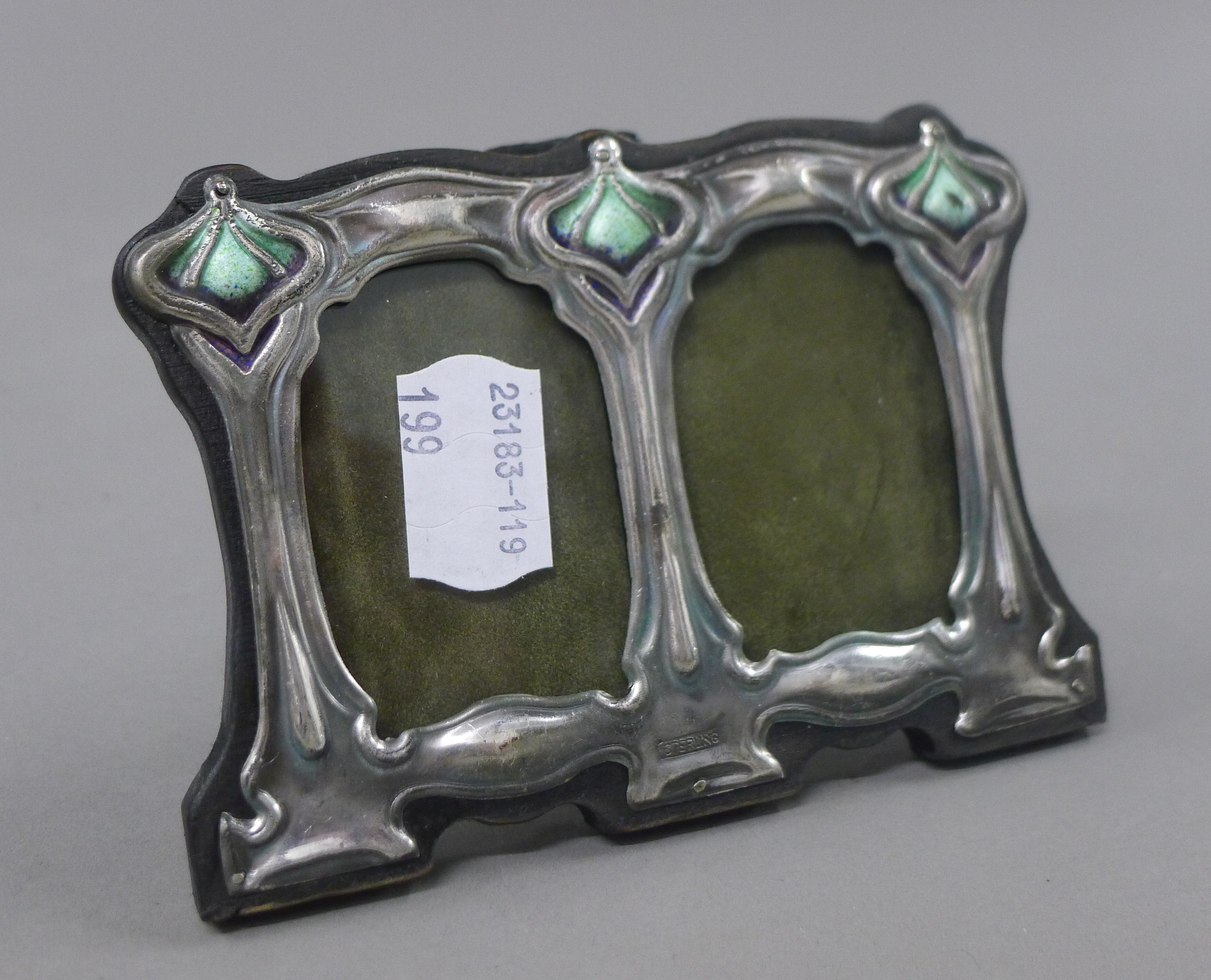 A sterling silver double photograph frame. 11 cm wide.