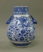 A Chinese porcelain blue and white vase with deer's head handles. 30 cm high.