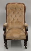 A Victorian mahogany framed upholstered open armchair. 64 cm wide.