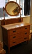 An early 20th century oak dressing table and three chairs.