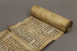 An early rolled Hebrew text scroll on parchment.